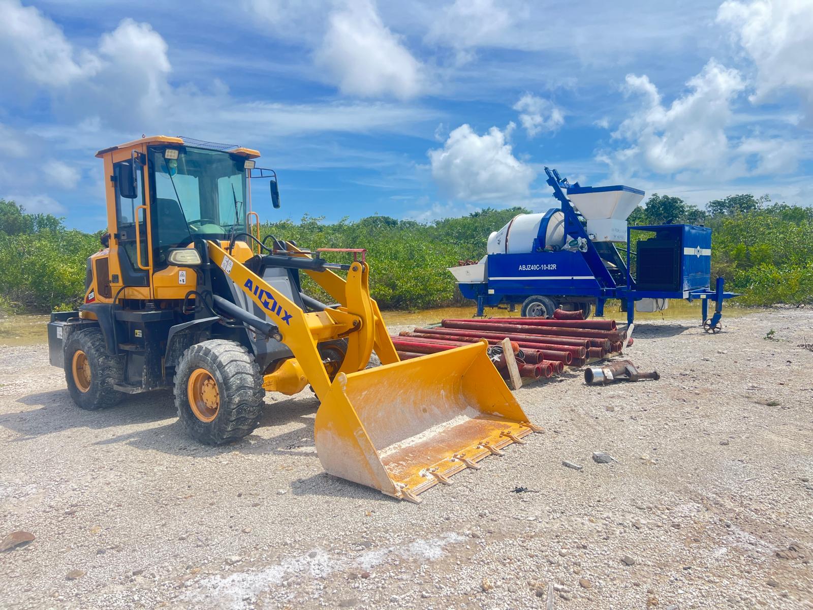 Wheel loader and concrete mixer pump on an Ambergris Caye work site
